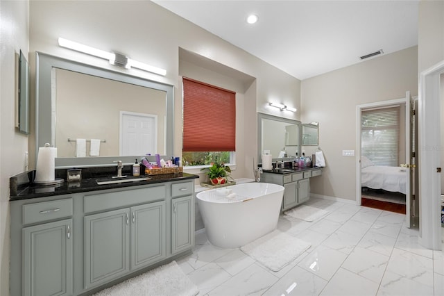 3000 Naughton Way, Tarpon Springs, FL 34688 - bathroom featuring a soaking tub, vanity, marble look tiles, ensuite bath, and recessed lighting
