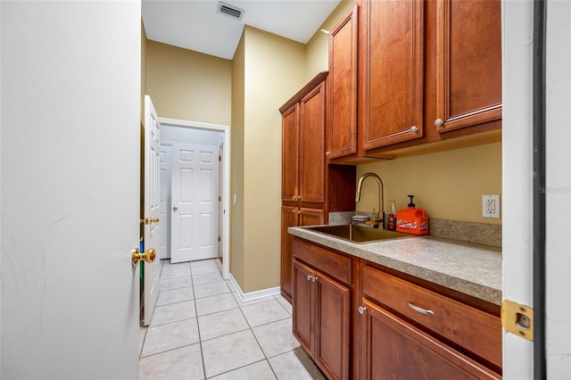 3000 Naughton Way, Tarpon Springs, FL 34688 - washroom with a sink, light tile patterned flooring, and baseboards