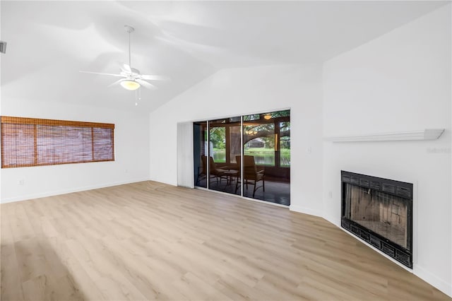 13898 Egret Ln, Clearwater, FL 33762 - unfurnished living room with a fireplace, wood finished floors, a ceiling fan, baseboards, and high vaulted ceiling