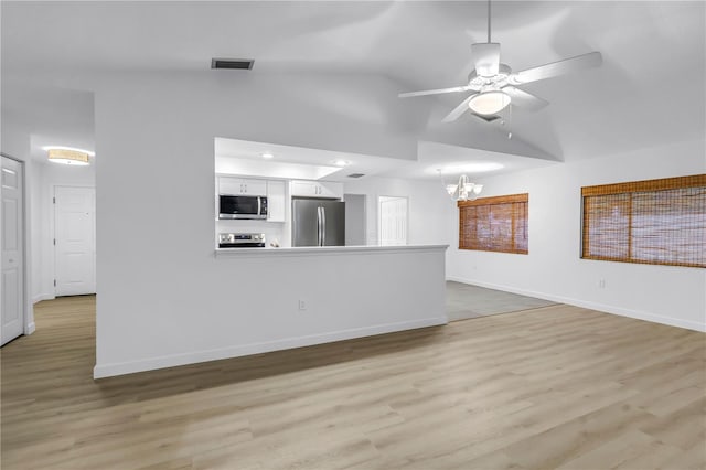 13898 Egret Ln, Clearwater, FL 33762 - unfurnished living room featuring a chandelier, ceiling fan, light wood-type flooring, baseboards, and high vaulted ceiling