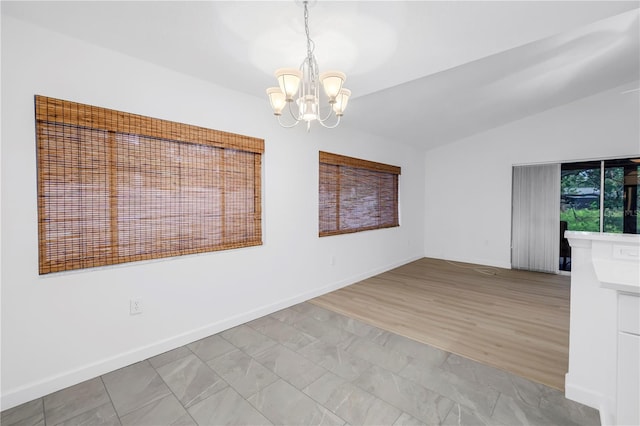 13898 Egret Ln, Clearwater, FL 33762 - unfurnished room featuring a chandelier, lofted ceiling, and baseboards