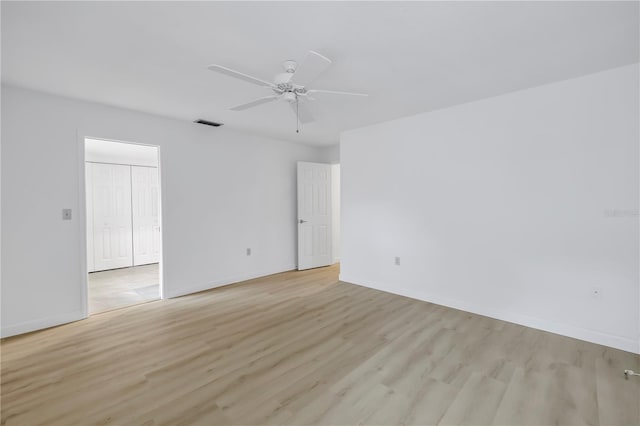 13898 Egret Ln, Clearwater, FL 33762 - spare room with light wood-type flooring, a ceiling fan, and baseboards
