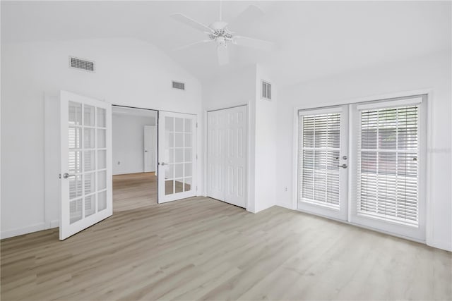 13898 Egret Ln, Clearwater, FL 33762 - unfurnished bedroom featuring french doors, access to outside, light wood-style floors, ceiling fan, and high vaulted ceiling