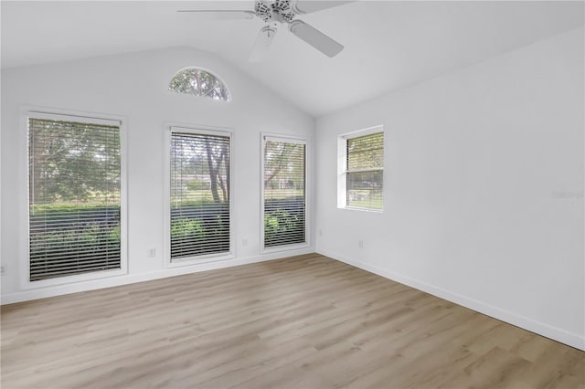 13898 Egret Ln, Clearwater, FL 33762 - empty room featuring healthy amount of natural light, lofted ceiling, light wood finished floors, ceiling fan, and baseboards