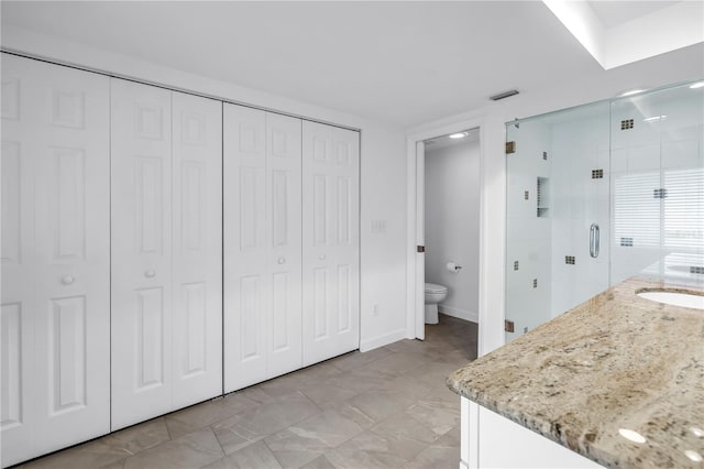 13898 Egret Ln, Clearwater, FL 33762 - full bathroom featuring a closet, a shower stall, toilet, and vanity