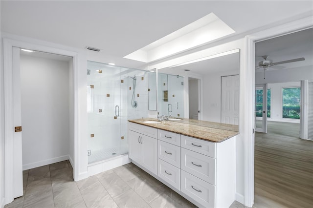 13898 Egret Ln, Clearwater, FL 33762 - full bathroom with vanity, a stall shower, a ceiling fan, and baseboards