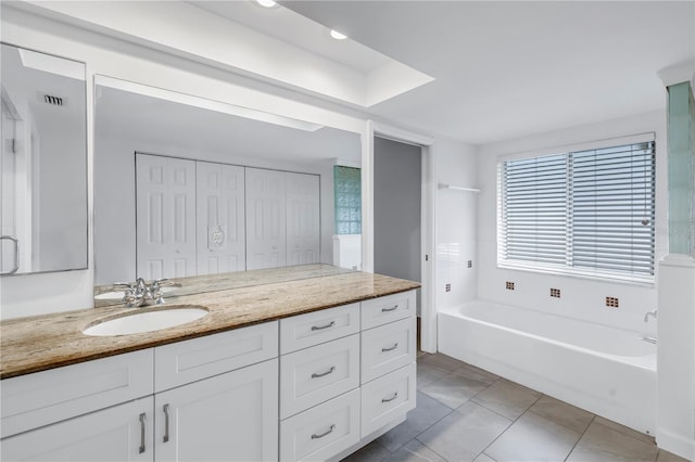 13898 Egret Ln, Clearwater, FL 33762 - bathroom with a tub to relax in, vanity, and tile patterned floors