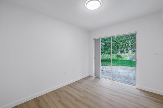 13898 Egret Ln, Clearwater, FL 33762 - spare room featuring light wood finished floors and baseboards