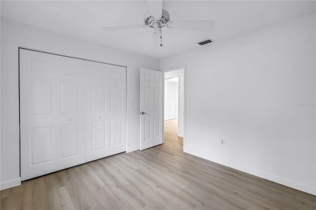 13898 Egret Ln, Clearwater, FL 33762 - unfurnished bedroom with baseboards, wood finished floors, a closet, and a ceiling fan