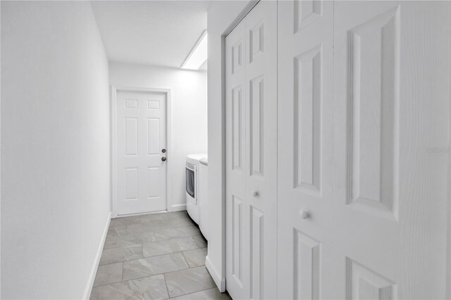 13898 Egret Ln, Clearwater, FL 33762 - laundry room with light marble finish floors, baseboards, and washer / clothes dryer