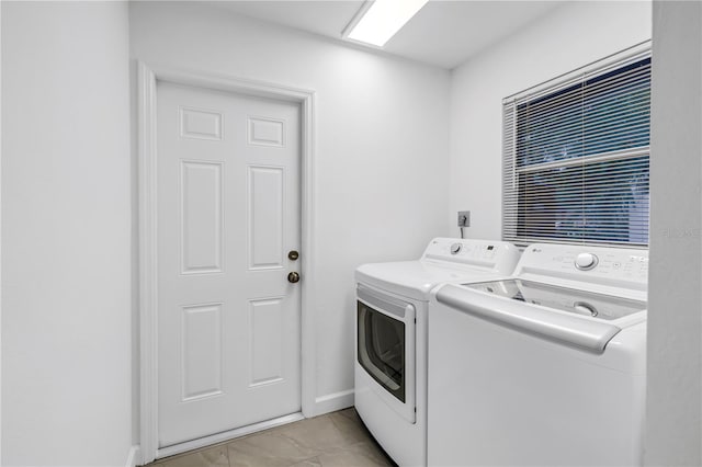 13898 Egret Ln, Clearwater, FL 33762 - washroom with washing machine and dryer, baseboards, and light marble finish flooring