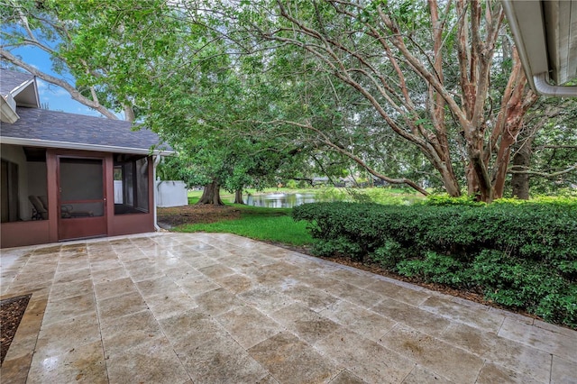 13898 Egret Ln, Clearwater, FL 33762 - view of patio featuring a sunroom and a water view