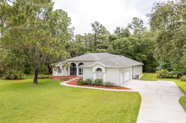 8444 Shenandoah Run, Wesley Chapel, FL 33544 - view of front facade featuring concrete driveway, a garage, a front yard, stucco siding, and roof with shingles