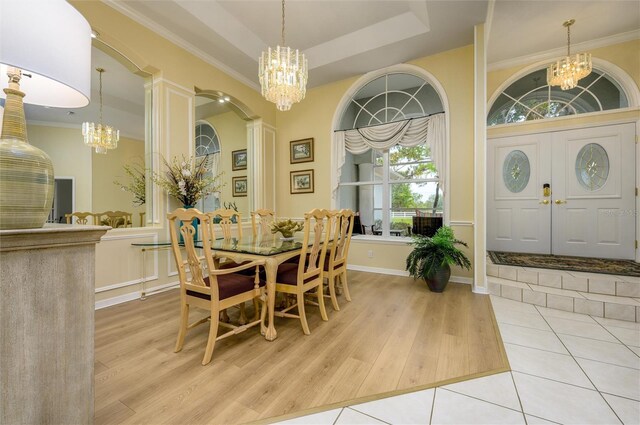 8444 Shenandoah Run, Wesley Chapel, FL 33544 - dining space with a chandelier, ornamental molding, wood finished floors, and a tray ceiling