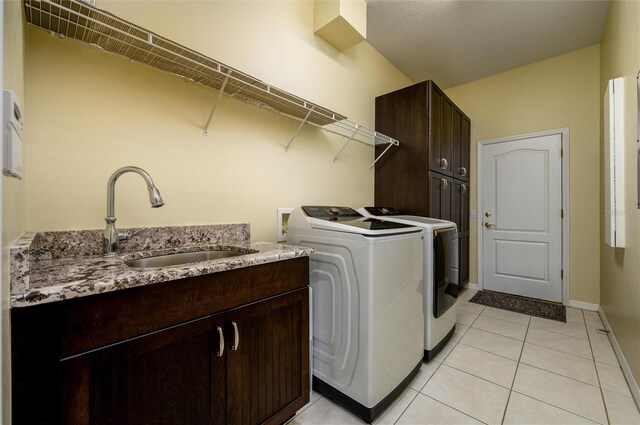 8444 Shenandoah Run, Wesley Chapel, FL 33544 - laundry room with separate washer and dryer, cabinet space, light tile patterned floors, and baseboards