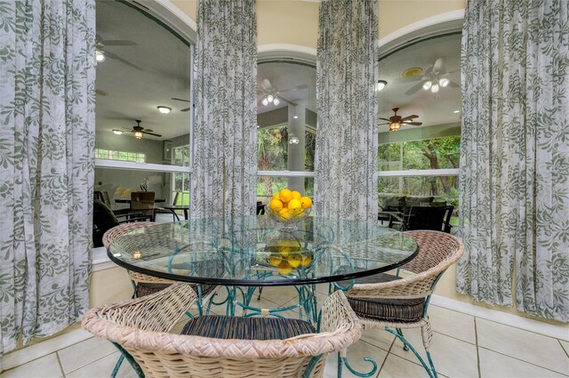 8444 Shenandoah Run, Wesley Chapel, FL 33544 - dining area featuring tile patterned floors, a ceiling fan, and arched walkways