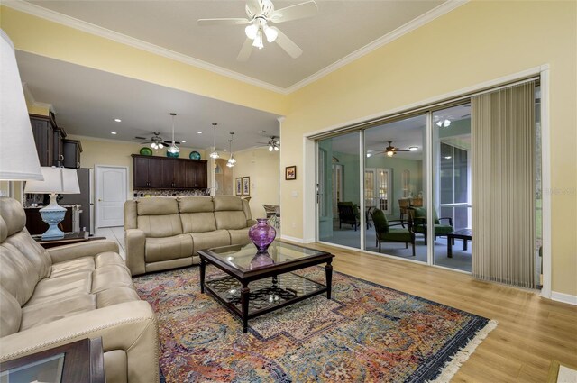8444 Shenandoah Run, Wesley Chapel, FL 33544 - living room featuring a ceiling fan, light wood-style flooring, crown molding, baseboards, and recessed lighting