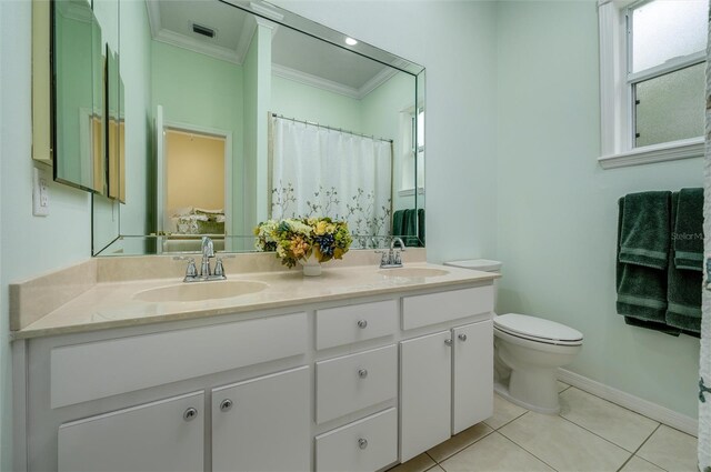 8444 Shenandoah Run, Wesley Chapel, FL 33544 - full bathroom featuring crown molding, double vanity, toilet, tile patterned flooring, and baseboards