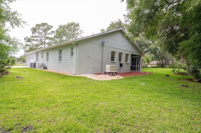 8444 Shenandoah Run, Wesley Chapel, FL 33544 - rear view of house with central air condition unit, stucco siding, and a lawn