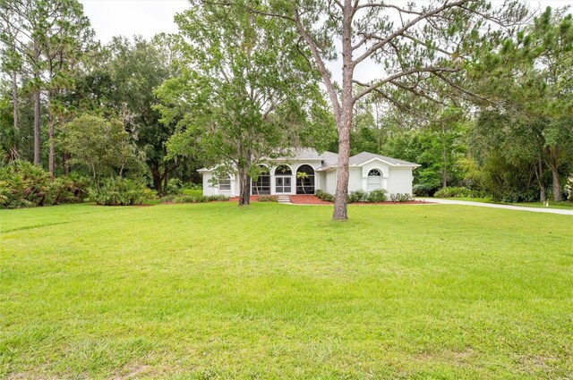 8444 Shenandoah Run, Wesley Chapel, FL 33544 - view of front facade featuring a front lawn and stucco siding