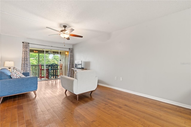 1028 Apollo Beach Blvd Unit 203, Apollo Beach, FL 33572 - living area with wood-type flooring, ceiling fan, and a textured ceiling