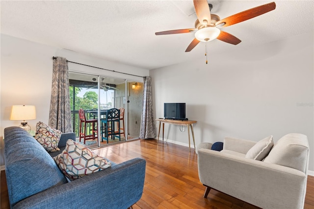 1028 Apollo Beach Blvd Unit 203, Apollo Beach, FL 33572 - living area featuring ceiling fan, wood finished floors, and a textured ceiling