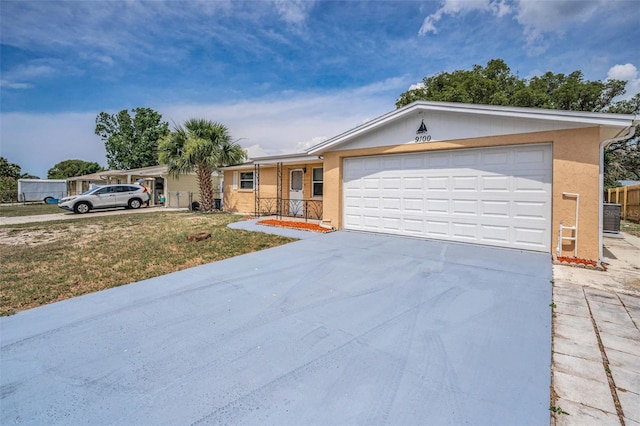 9100 Lunar Ln, Port Richey, FL 34668 - view of front of house featuring driveway, an attached garage, a front lawn, stucco siding, and cooling unit