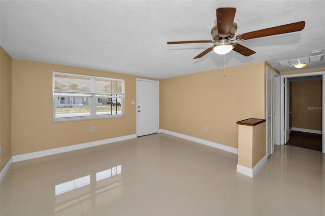 9100 Lunar Ln, Port Richey, FL 34668 - tiled spare room with ceiling fan and baseboards