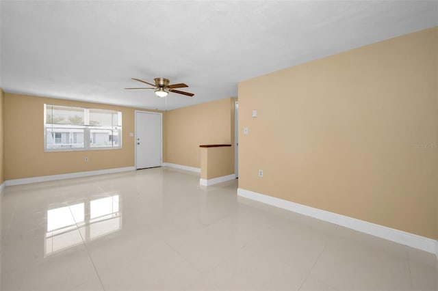 9100 Lunar Ln, Port Richey, FL 34668 - spare room featuring ceiling fan, light tile patterned floors, and baseboards