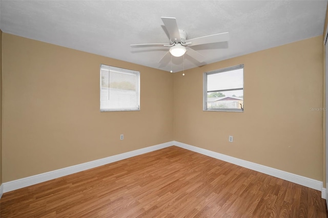 9100 Lunar Ln, Port Richey, FL 34668 - empty room featuring light wood-style flooring, baseboards, and a ceiling fan