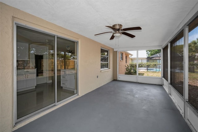 9100 Lunar Ln, Port Richey, FL 34668 - unfurnished sunroom featuring a ceiling fan