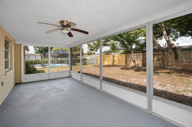 9100 Lunar Ln, Port Richey, FL 34668 - unfurnished sunroom with ceiling fan and plenty of natural light