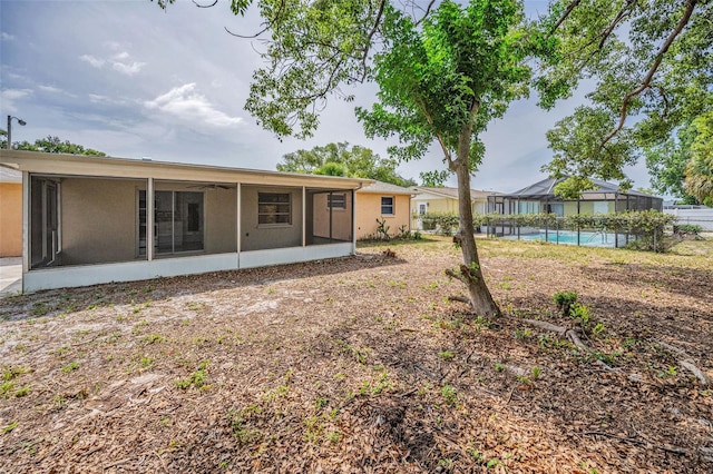 9100 Lunar Ln, Port Richey, FL 34668 - rear view of property with a sunroom
