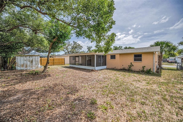 9100 Lunar Ln, Port Richey, FL 34668 - back of house with a sunroom and stucco siding