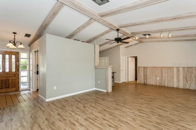2035 Nolan Dr, Dunedin, FL 34698 - unfurnished living room with wood finished floors, a chandelier, and a ceiling fan