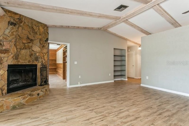 2035 Nolan Dr, Dunedin, FL 34698 - unfurnished living room featuring wood finished floors, a fireplace, and built in features