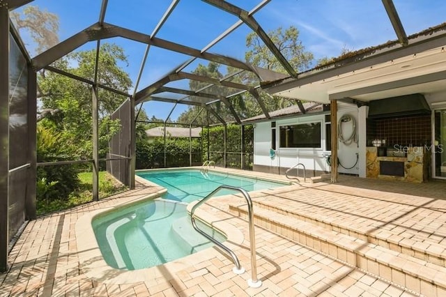 2035 Nolan Dr, Dunedin, FL 34698 - swimming pool with a patio and glass enclosure