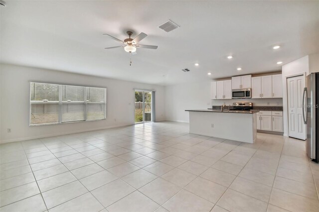 9828 Branching Ship Trce, Wesley Chapel, FL 33545 - kitchen featuring stainless steel appliances, open floor plan, dark countertops, recessed lighting, and a ceiling fan