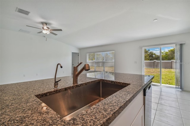 9828 Branching Ship Trce, Wesley Chapel, FL 33545 - kitchen with a sink, white cabinets, dark stone counters, lofted ceiling, and stainless steel dishwasher