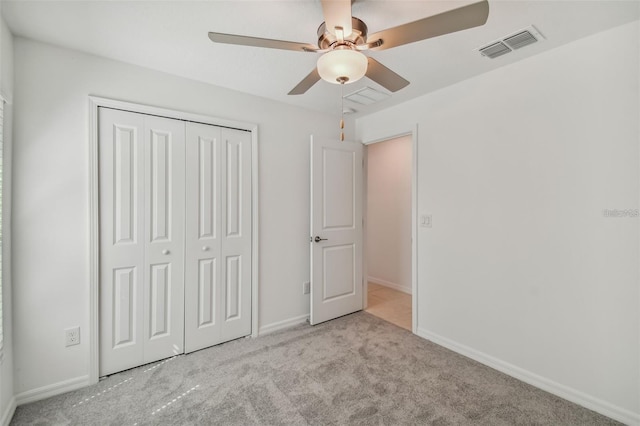 9828 Branching Ship Trce, Wesley Chapel, FL 33545 - unfurnished bedroom featuring carpet, a closet, baseboards, and a ceiling fan