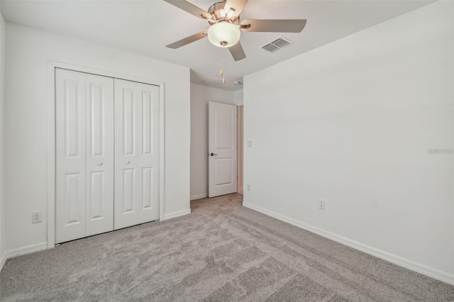 9828 Branching Ship Trce, Wesley Chapel, FL 33545 - unfurnished bedroom featuring carpet, baseboards, a closet, and ceiling fan