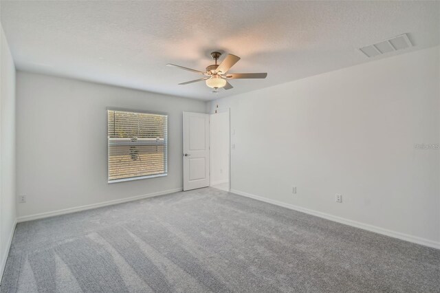 9828 Branching Ship Trce, Wesley Chapel, FL 33545 - carpeted spare room featuring ceiling fan, a textured ceiling, and baseboards