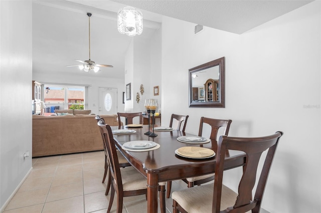 10213 Westport Ct, Tampa, FL 33615 - dining area with light tile patterned floors, baseboards, ceiling fan, and high vaulted ceiling