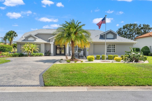9276 Ashley Dr, Weeki Wachee, FL 34613 - single story home with a front lawn, stucco siding, and driveway