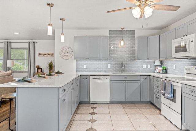 3956 N Tamarisk Pt, Beverly Hills, FL 34465 - kitchen featuring white appliances, gray cabinetry, a peninsula, a sink, and a ceiling fan