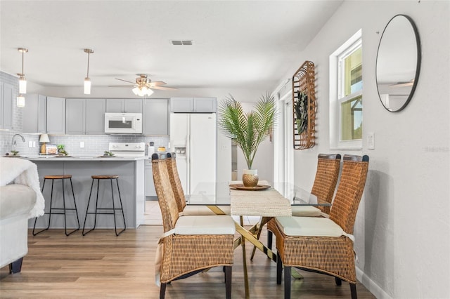 3956 N Tamarisk Pt, Beverly Hills, FL 34465 - dining room with light wood finished floors and a ceiling fan