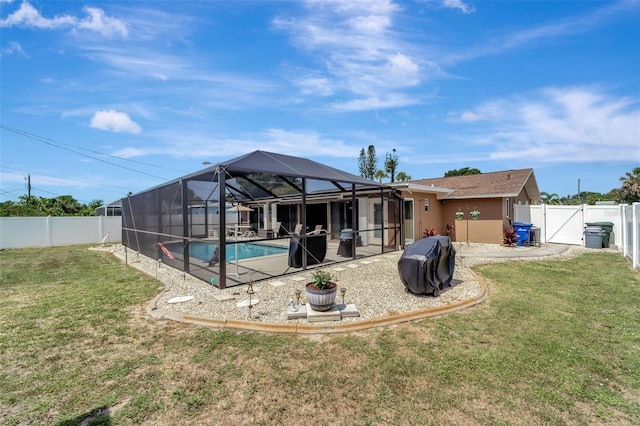 260 Venice E Blvd, Venice, FL 34293 - rear view of house with a patio, a gate, glass enclosure, and stucco siding