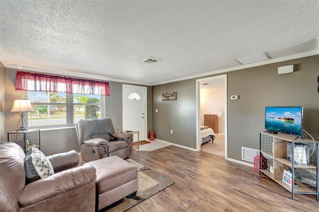 260 Venice E Blvd, Venice, FL 34293 - living area with a textured ceiling, ornamental molding, wood finished floors, and baseboards
