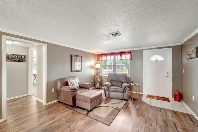 260 Venice E Blvd, Venice, FL 34293 - living room with crown molding, wood finished floors, a textured ceiling, and baseboards
