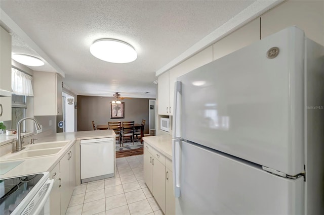 260 Venice E Blvd, Venice, FL 34293 - kitchen with white appliances, a sink, light countertops, light tile patterned flooring, and a textured ceiling
